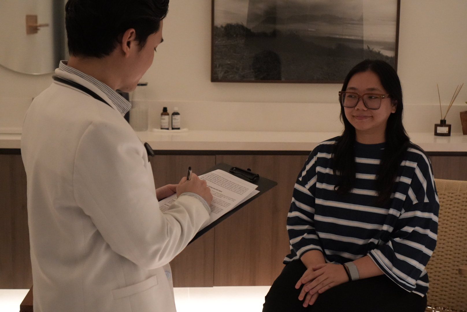A Longevity Labs physician taking notes with a client during a consultation